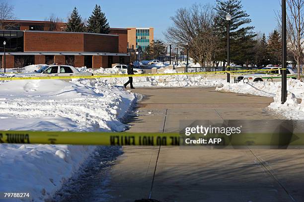 Police secure the crime scene on February 15, 2008 after a shooting spree at Cole Hall on the Northern Illinois University campus in DeKalb,...