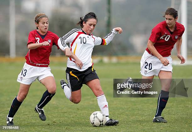 Nadine Kessler of Germany gets between Brittany Klein and Yael Averbuch of the U.S. During their U23 women's friendly football match at the La Manga...
