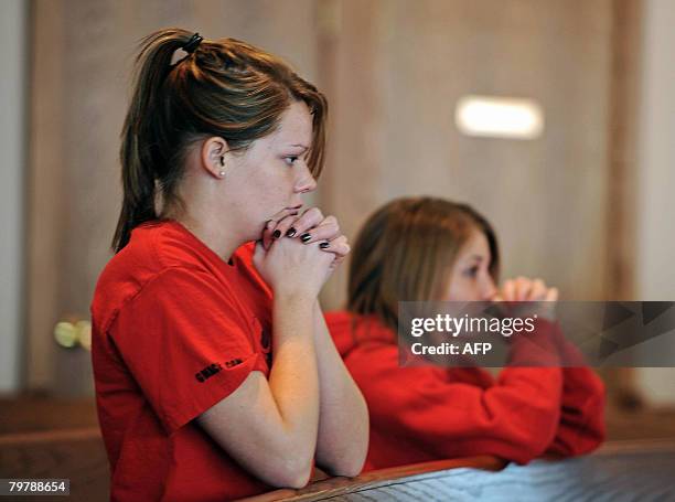 Mourners pray at the Newman Center on the Northern Illinois University campus in DeKalb, Illinois, on February 15 during a mass following a deadly...