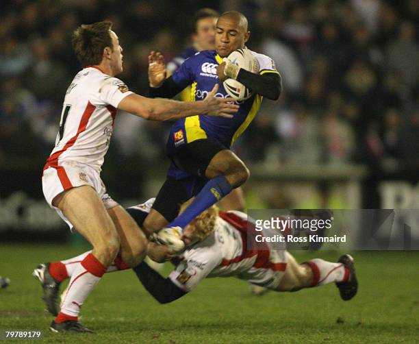 Kevin Penny of Warrington is tackled by James Roby and James Graham of St Helens during the Super Leaue match between St. Helens and Warrington...