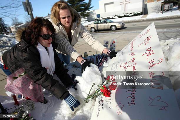 Linze Greibenow , 18 and Liz Freise both of nearby Kishwaukee Community College, place flowers and cards near Cole Hall at Northern Illinois...