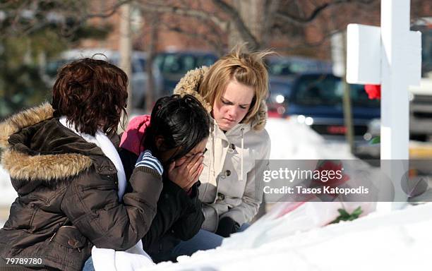 Students gather and place flowers near Cole Hall on the campus of Northern Illinois University Hall February 15, 2008 in DeKalb, Illinois. Six people...