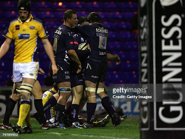Chris Bell of Sale is congratulated by his team mates after scoring a try during the Guinness Premiership match between Sale Sharks and Leeds...