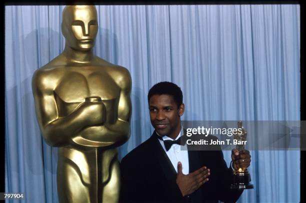 Denzel Washington stands backstage during the 62nd Academy Awards ceremony March 26, 1990 in Los Angeles, CA. Washington received an Oscar for Best...