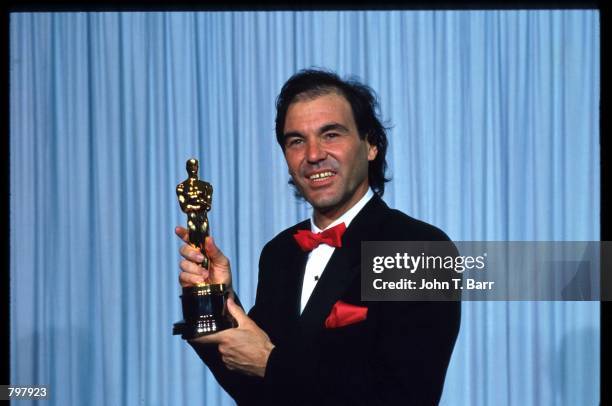 Oliver Stone stands backstage during the 62nd Academy Awards ceremony March 26, 1990 in Los Angeles, CA. Stone received an Oscar for Best Director...