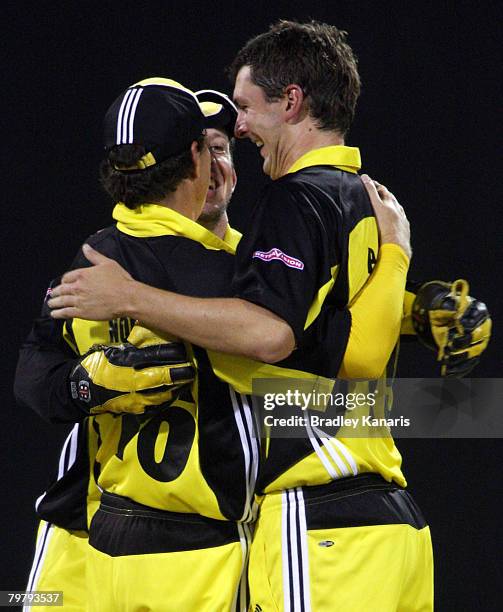 Paul Davis of the Warriors celebrates with team mates after taking a wicket during the Ford Ranger Cup match between the Queensland Bulls and the...