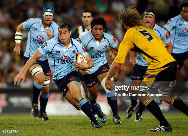 Timana Tahu of the Waratahs makes a break during the round one Super 14 match between the New South Wales Waratahs and the Hurricanes at Sydney...