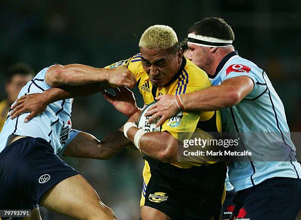 Jerry Collins of the Hurricanes is tackled during the round one Super 14 match between the New South Wales Waratahs and the Hurricanes at the Sydney...