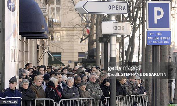 People stand in front of of the Madeleine Church in Paris during French crooner Henri Salvador's funeral ceremony on February 16, 2008. The all-round...