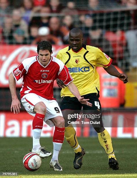 Danny Shittu of Watford challenges Andy Gray of Charlton Athletic during the Coca-Cola Championship match between Charlton Athletic and Watford,...