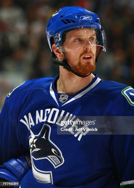 Daniel Sedin of the Vancouver Canucks looks on from the bench during their game against the Minnesota Wild at General Motors Place on February 14,...