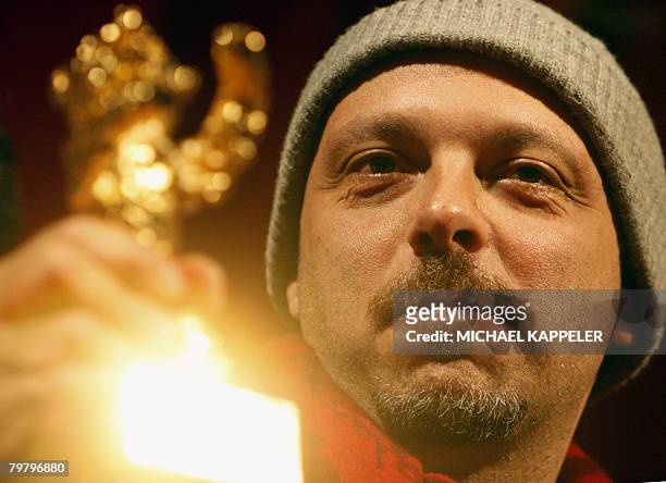 Brazilian director Jose Padilha celebrates with the Golden Bear prize for best picture for the movie "Tropa de Elite" during the awards ceremony of...