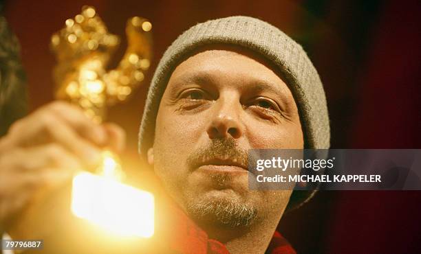 Brazilian director Jose Padilha celebrates with the Golden Bear prize for best picture for the movie "Tropa de Elite" during the awards ceremony of...