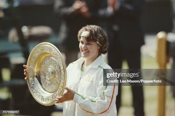 Czech born Swiss tennis player Martina Hingis holds the Venus Rosewater Dish trophy up in the air after winning the final of the Women's Singles...