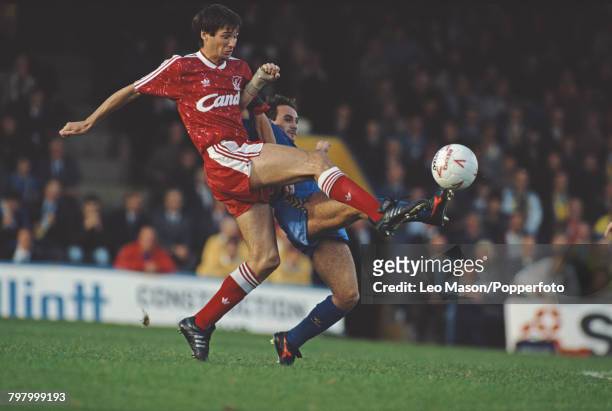 Alan Hansen of Liverpool and Terry Gibson of Wimbledon clash for the ball during a League Division One game between Wimbledon and Liverpool at Plough...
