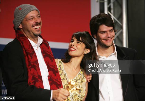 Director Jose Padilha, actress Maria Ribeiro and producer Eduardo Constantini Jr pose with the Golden Bear for the Best Film for The Elite Squad...