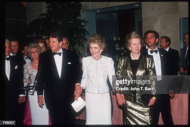 Ronald Reagan, wife Nancy and former British Prime Minister Margaret Thatcher hold hands at his eightieth birthday celebration at the Beverly Hilton...