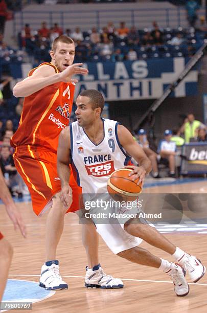 Spain's Fran Vazquez has no answer for the quickness of France's Tony Parker has he speeds past him towards the basket during the Bronze medal match...