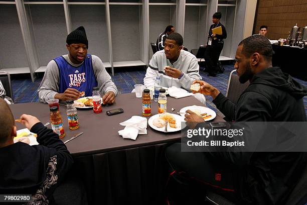 Dwyane Wade, Joe Johnson and LeBron James of the East All-Stars eat breakfast prior to the East All-Stars Practice on center court at NBA Jam Session...