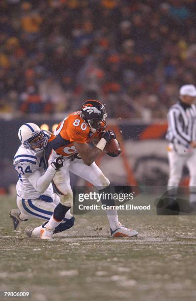 Wide receiver Rod Smith of the Denver Broncos cathes a pass against Jason Doering of the Indianapolis Colts at Invesco Field in Denver, Colorado on ....