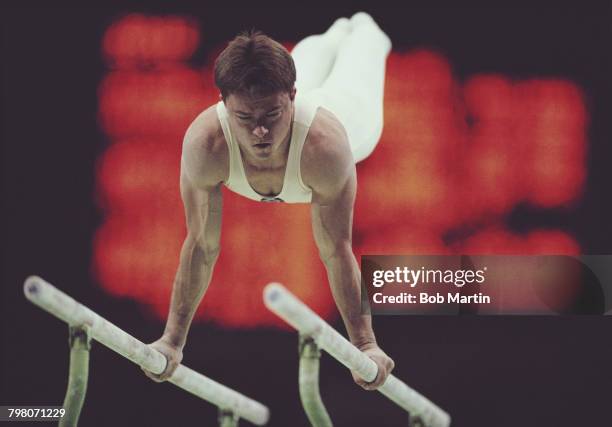 Vladimir Artemov of the Soviet Union performs during the Men's Parallel Bars on 24 September 1988 during the XXIV Summer Olympic Games at the Olympic...