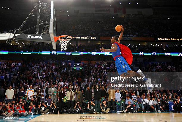 Dwight Howard of the Orlando Magic completes his Superman dunk during the Sprite Slam Dunk Contest part of 2008 NBA All-Star Weekend at the New...