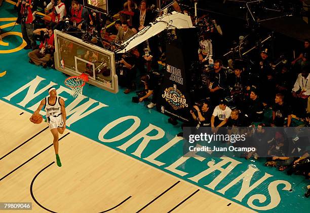 Gerald Green of the Minnesota Timberwolves completes a through the leg dunk with no sneakers on his feet during the Sprite Slam Dunk Contest part of...