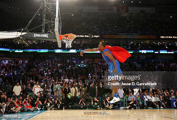 Dwight Howard of the Orlando Magic completes his Superman dunk during the Sprite Slam Dunk Contest part of 2008 NBA All-Star Weekend at the New...