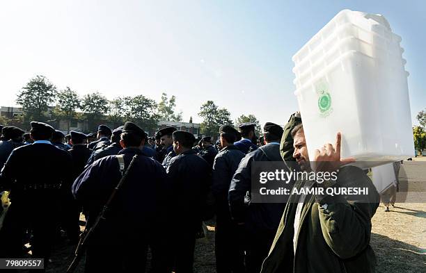 Pakistani election official carries election material at a distribution centre in Islamabad on February 17, 2008. Pakistan will hold on February 18,...