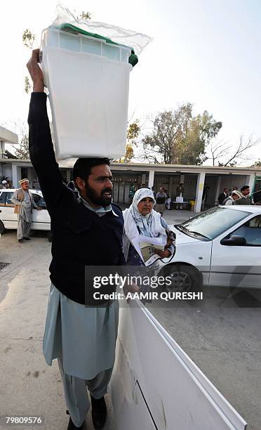 Pakistani election official carries election material at a distribution centre in Islamabad on February 17, 2008. Pakistan will hold on February 18,...