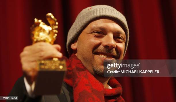 Brazilian director Jose Padilha celebrates with the Golden Bear prize for best picture for the movie "Tropa de Elite" during the awards ceremony of...