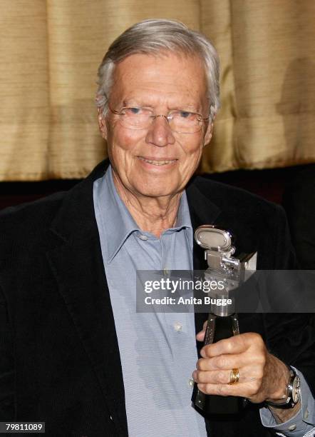 Karlheinz Boehm with his award presented to him by Berlinale Festival Director Dieter Kosslick, during a Tribute reception as part of the 58th...