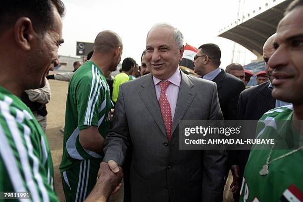 Former deputy prime minister Ahmed Chalabi shakes hands with football players from Kadhimiyah, a Shiite neighbourhood, and Adhamiyah, a Sunni...