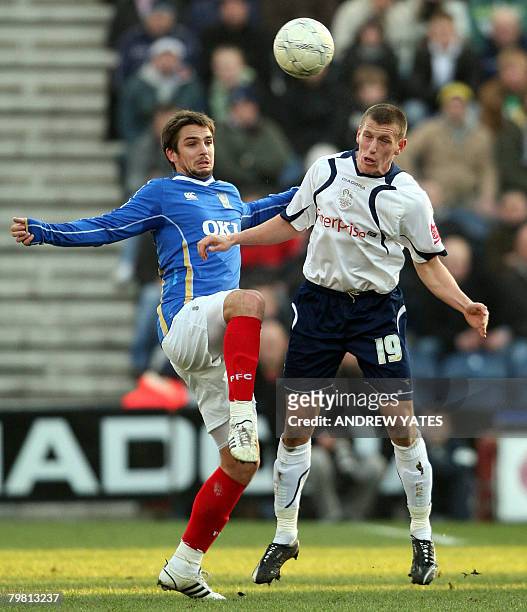 Preston's Billy Jones vies with Portsmouth's Nike Kranjcar during the FA Cup fifth round football match at Deepdale, Preston, north-west England on...