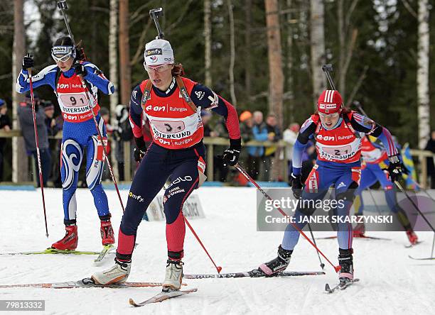 Italy's Michaela Ponza, France's Delphine Peretto and Russia's Svetlan Sleptsova power during the women's 4x6 km relay on the last day of Biathlon...