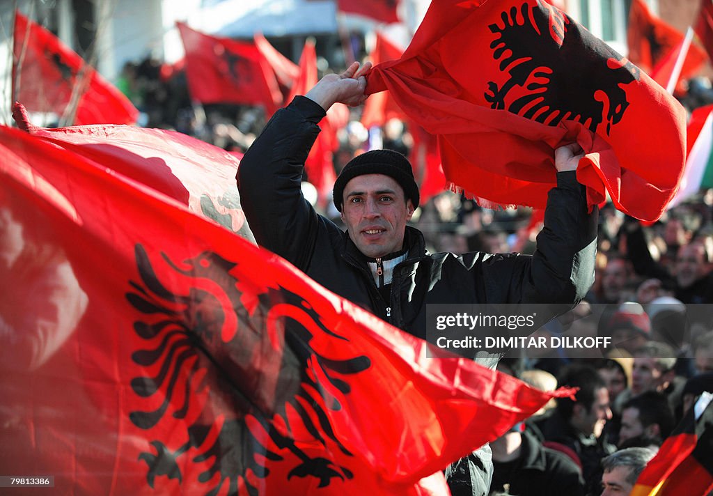 A Kosovar wave an Albanian flag as celeb