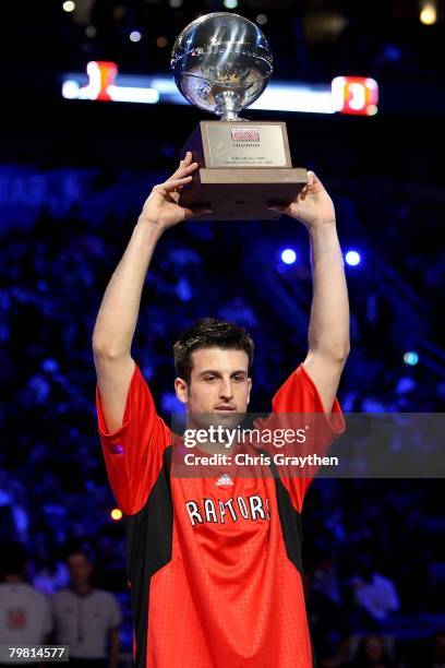 Jason Kapono of the Toronto Raptors holds up the championship trophy after winning the Foot Locker Three-Point Shootout, part of 2008 NBA All-Star...