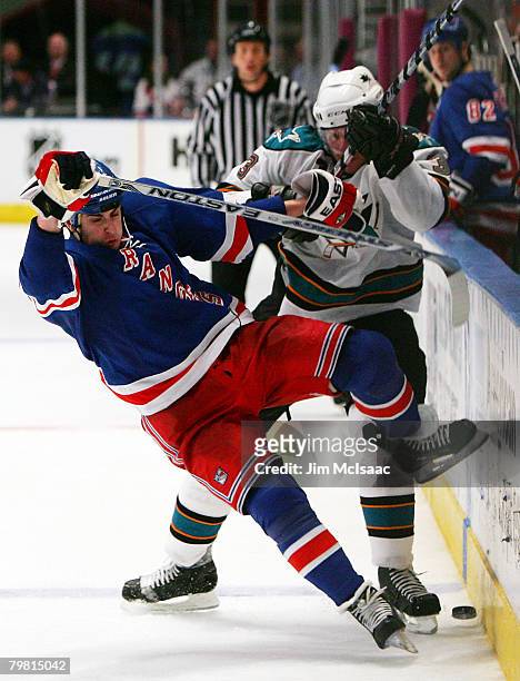 Brandon Dubinsky of the New York Rangers is sent to the ice by Douglas Murray of the San Jose Sharks on February 17, 2008 at Madison Square Garden in...