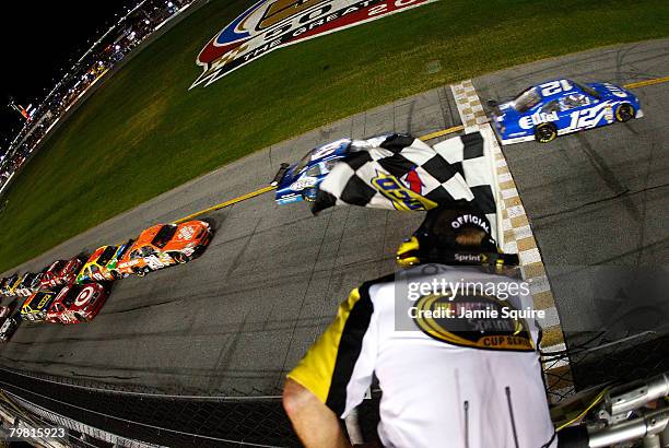 Ryan Newman, driver of the Alltel Dodge, crosses the finish line to win the 50th NASCAR Sprint Cup Series Daytona 500, ahead of teammate Kurt Busch,...