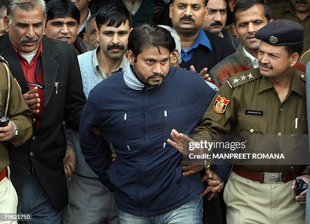Indian police officials escort Jeewan Rawat brother of accused Amit Kumar in a kidney transplant scandal after a court appearance in New Delhi on...