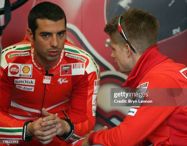 World Champion Casey Stoner of Australia and the Ducati Marlboro Team chats to team mate Marco Melandri during MotoGP Testing at the Circuito de...