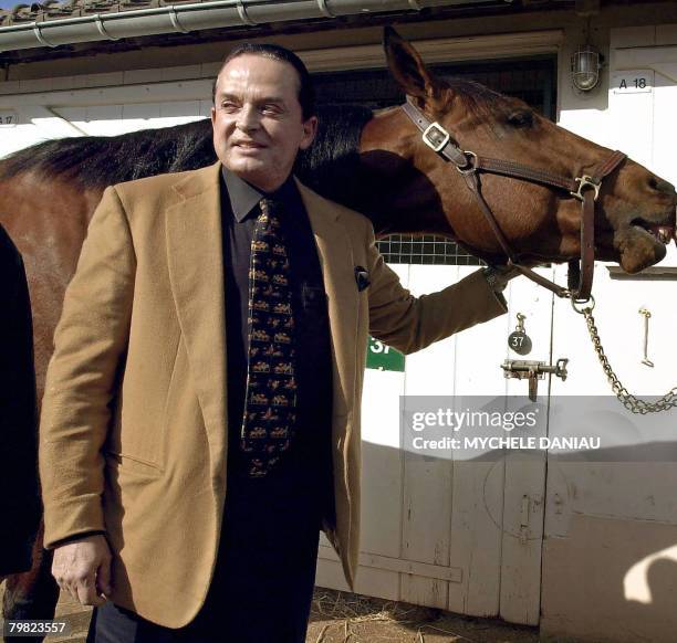 Photo taken 07 March 2002 in Deauville, western France, shows art dealer and horse owner Alec Wildenstein posing with his horse Kesaco Phedo, winner...