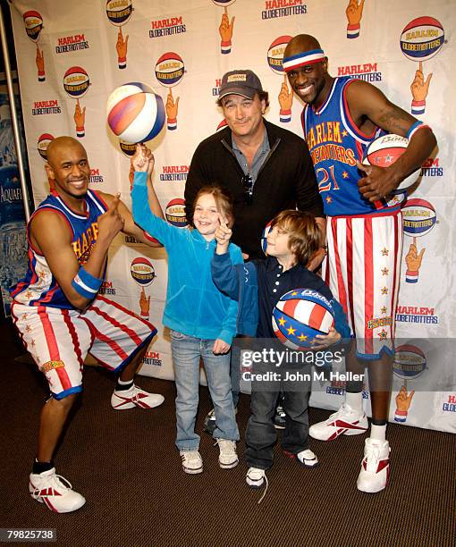 Jamison Belushi gets a little help with ball spinning from Scooter Christensen and Special K Daley with her dad, Jim Belushi and her little brother...