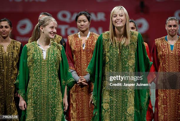 Maria Sharapova of Russia smiles with Anna Chakvetadze of Russia while wearing a Jalabya during the opening ceremony of the WTA Qatar Total Open at...