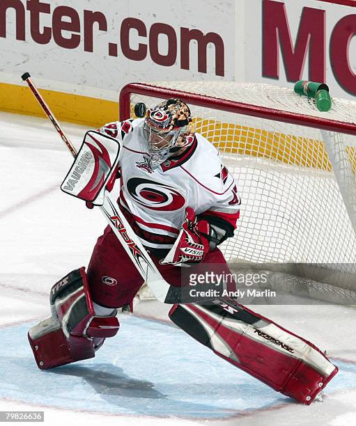 John Grahame of the Carolina Hurricanes makes a save with his mask against the New Jersey Devils during their game at the Prudential Center on...