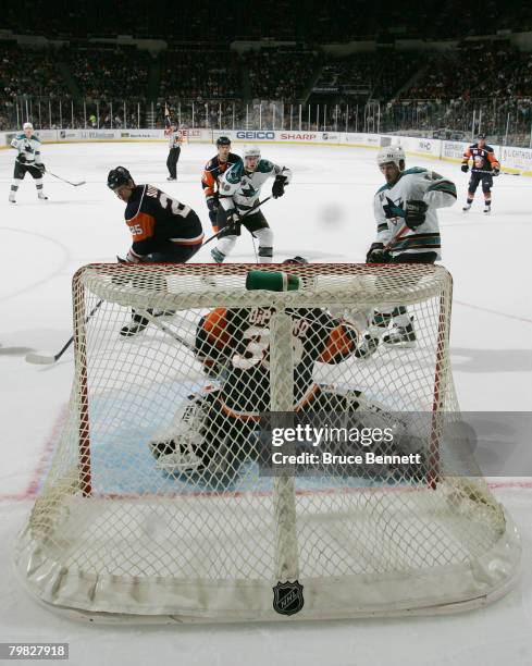 Jonathan Cheechoo of the San Jose Sharks is stopped by Rick DiPietro of the New York Islanders at the Nassau Coliseum February 18, 2008 in Uniondale,...