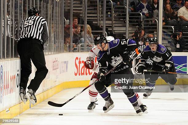Linesman Shane Heyer jumps up along the sideboards to avoid contact from Ted Purcell of the Los Angeles Kings during the game against the Phoenix...