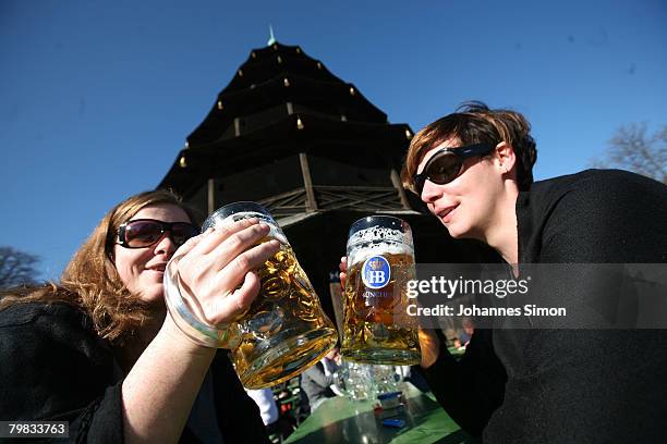 Jessica and Pascale drink beer sitting in the sun in front of Chinesischer Turm in the English Garden on February 19, 2008 in Munich, Germany....