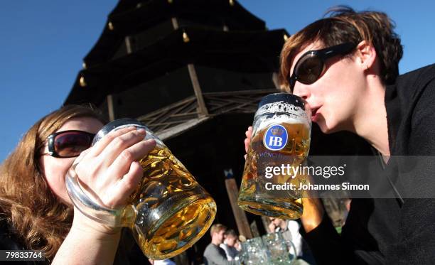 Jessica and Pascale drink beer sitting in the sun in front of Chinesischer Turm in the English Garden on February 19, 2008 in Munich, Germany....