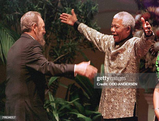 South African President Nelson Mandela greets Cuban leader Fidel Castro as he arrives for the opening of the 12th Non-Aligned Movement summit in...
